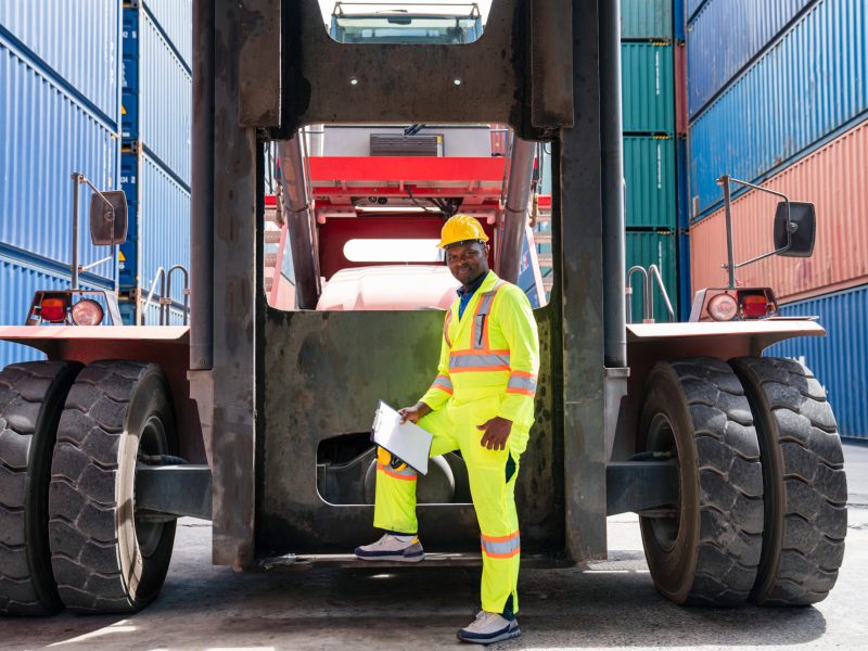 Male Container yard worker control and checking container. Male Container yard worker control and checking container at container yard warehouse. Logistics business. Import and export concept.