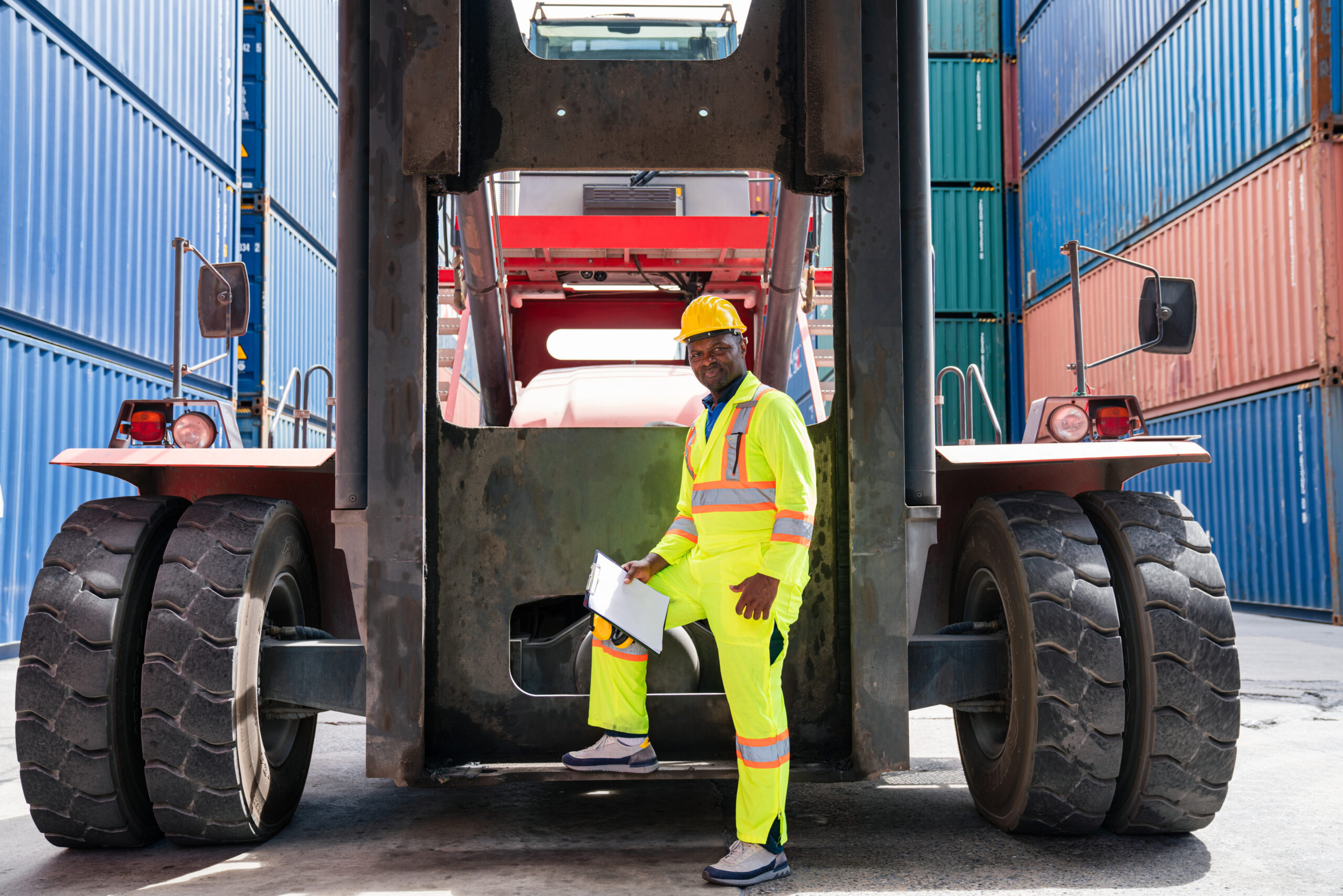 Male Container yard worker control and checking container. Male Container yard worker control and checking container at container yard warehouse. Logistics business. Import and export concept.